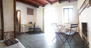 a room with a table and chairs and a desk at Chambre double in Vallon-en-Sully