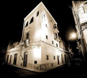 a large white building with lights on it at night at Bed & Breakfast Al Borgo in Gioia del Colle