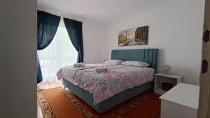 a bedroom with a bed with two stuffed animals on it at Apartments Gabriela in Poreč