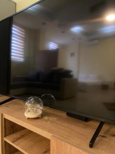 a flat screen tv sitting on top of a wooden table at Zezo Apartments in Bitola