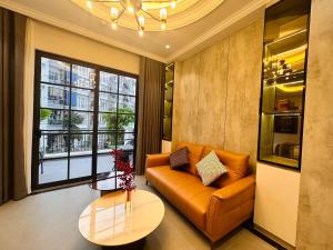 a living room with a couch and a table at 58 House - Mỹ Anh Homestay in Hai Phong
