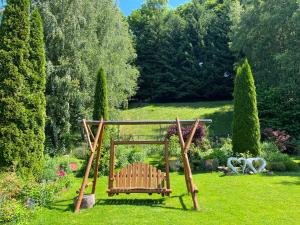 a garden with a swing in the grass at Willa Rubin in Kudowa-Zdrój