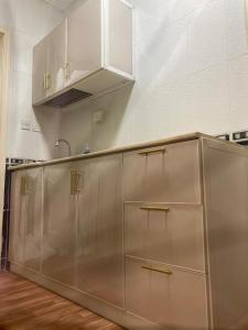a kitchen with stainless steel cabinets and a sink at Al-mohamdiah apartments in Makkah