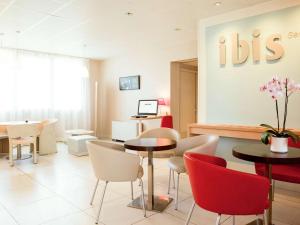 a waiting room with tables and chairs at ibis Senlis in Senlis