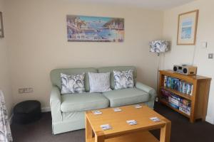 a living room with a couch and a coffee table at Two Bedroomed Holiday Cottage with Sea Views in St Austell