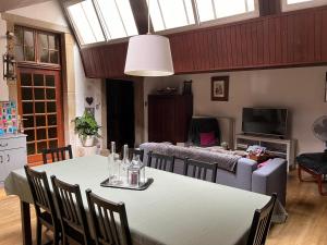 a living room with a table and a couch at Le Charles IX in Roussillon en Isere