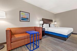 une chambre d'hôtel avec un lit et un canapé dans l'établissement Hampton Inn Mebane, à Mebane