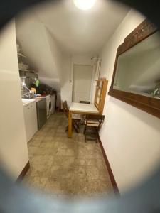 a small room with a table and a kitchen at I nespoli in Imola