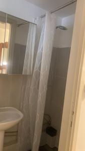 a bathroom with a shower curtain and a sink at I nespoli in Imola