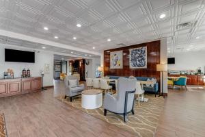 a lobby with a table and chairs and a television at Comfort Inn Thomasville I-85 in Thomasville