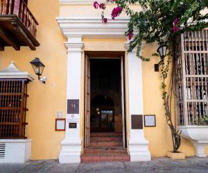 an entrance to a building with a door and flowers at Nacar Hotel Cartagena, Curio Collection by Hilton in Cartagena de Indias