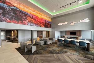 a lobby with a large painting on the wall at La Quinta Inn & Suites by Wyndham Yakima Downtown in Yakima