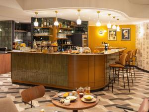 a bar in a restaurant with tables and chairs at Le Splendid Hotel Lac D'Annecy - Handwritten Collection in Annecy