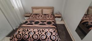 a bedroom with a bed with a blanket on it at Thes house in Thessaloniki