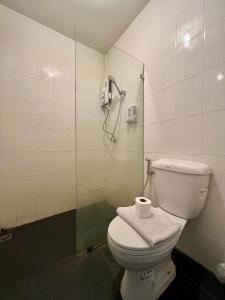 a bathroom with a toilet and a shower at Ngeeb bed and EV station in Chiang Rai