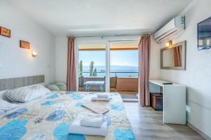 a bedroom with a bed with a view of the ocean at Villa Tesla in Ohrid +13 photos