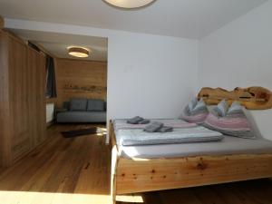 a bedroom with a wooden bed in a room at unique large alpine pasture in the middle of the Zillertal mountains in Zellberg