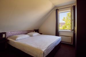 a bedroom with a large bed with a window at Van der Valk Resort Linstow in Linstow +69 photos