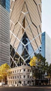 a large building with a triangle on the side of it at Paragon Apartment Penthouse Amazing Views, Spacious & Great Location in Melbourne