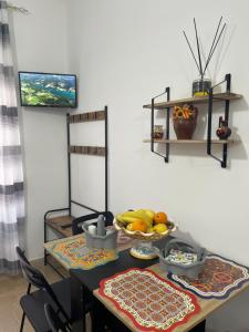 a table with a bowl of fruit on it at La Casuzza del Borgo in Agrigento +21 photos