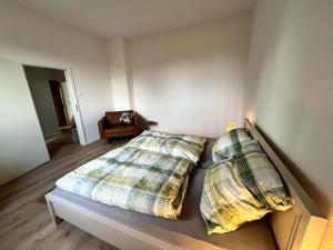 a bedroom with two pillows on a bed with a chair at Soleblick in Salzelmen