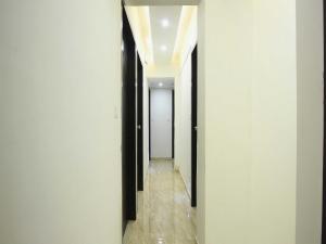 a hallway with black and white walls and wooden floors at OYO Hotel Dream Inn in Sarkhej