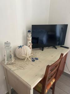 a table with a tv on top of it at Lilli's House in Gallipoli +7 photos