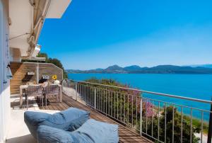 a balcony with a view of the water at Meteora Suites in Nikiana