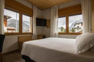 Postel nebo postele na pokoji v ubytování Chalet Cridola Dolomiti Experience