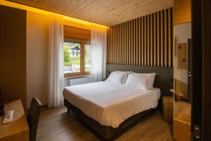 Postel nebo postele na pokoji v ubytování Chalet Cridola Dolomiti Experience