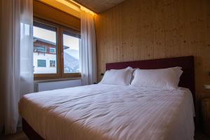 Postel nebo postele na pokoji v ubytování Chalet Cridola Dolomiti Experience