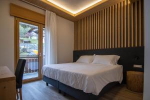 Postel nebo postele na pokoji v ubytování Chalet Cridola Dolomiti Experience