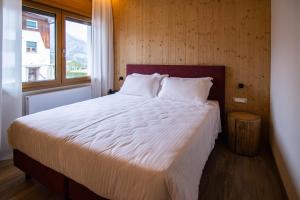 Postel nebo postele na pokoji v ubytování Chalet Cridola Dolomiti Experience