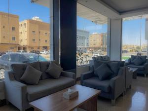 a lobby with couches and a table and a car in a parking lot at فندق آبل Apple Hotel in Riyadh
