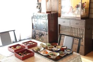 a table with bowls of food on top of it at Shukubo Daishinbo in Tsuruoka