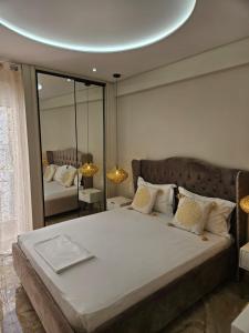 a bedroom with a large bed with a round ceiling at AGORA luxury APARTMENT 10 in Loutraki