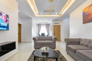 a living room with a couch and a table at Firenze Apartments Lekki in Lagos