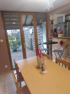 a kitchen with a wooden table and a dining room at Le Petit Veternat in Ventron