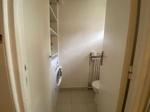 a bathroom with a toilet and a washing machine at Lovely Flat 4 peoples in Saint-Cloud