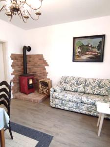 a living room with a couch and a wood stove at Haus im Erholungsgebiet Detern in Detern