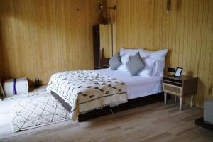 a bedroom with a bed and a table with a night stand at Domain The blaze in Marrakech