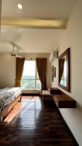 a bedroom with a bed and a large window at Luxury Apartment with Panoramic City Views in Islamabad