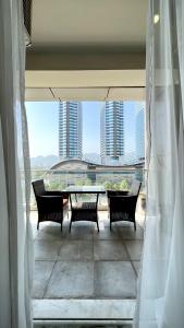 a view of a balcony with a table and chairs at Luxury Apartment with Panoramic City Views in Islamabad