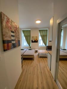 a living room with two beds and a kitchen at MINATO Apartments Ostrava center in Ostrava