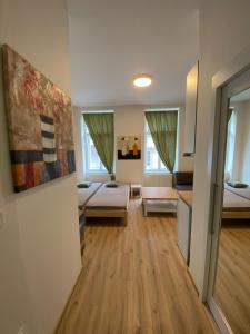 a living room with two beds and a kitchen at MINATO Apartments Ostrava center in Ostrava +259 photos
