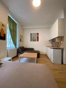a living room with a couch and a table at MINATO Apartments Ostrava center in Ostrava