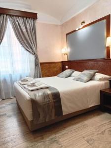 ein Schlafzimmer mit einem großen Bett und einem großen Spiegel in der Unterkunft Korean Sonata in Rom