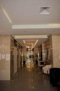 a lobby of a building with a hallway with tables at Luxury Apartment with Panoramic City Views in Islamabad