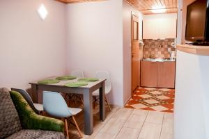 a kitchen and dining room with a table and chairs at Apartament EmKa z balkonem Rowy in Rowy