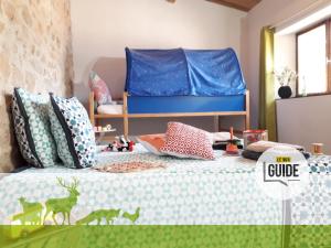 a childs bedroom with a bed with a blue headboard at Odyssée-Auvergne in Vallon-en-Sully
